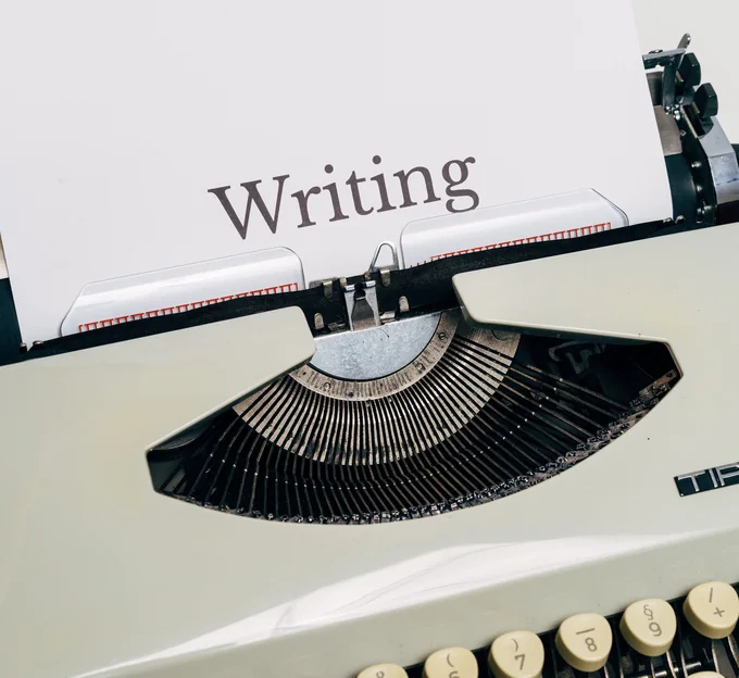 A typewriter with the word Writing on the page
