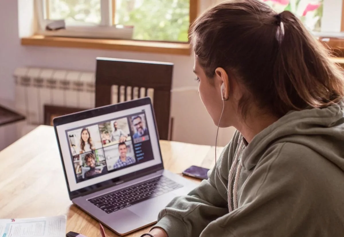 A young person studying on a video call at home